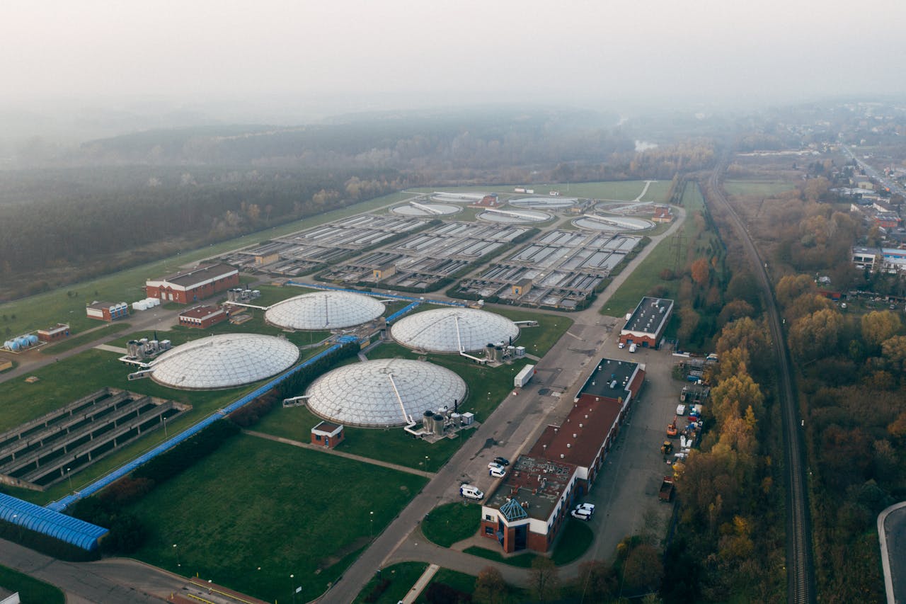 mobile-02 Aerial shot of a wastewater treatment facility in Poznań, showcasing industrial technology and environmental effort.